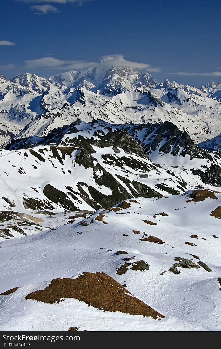 Snow covered mountains with a blue sky