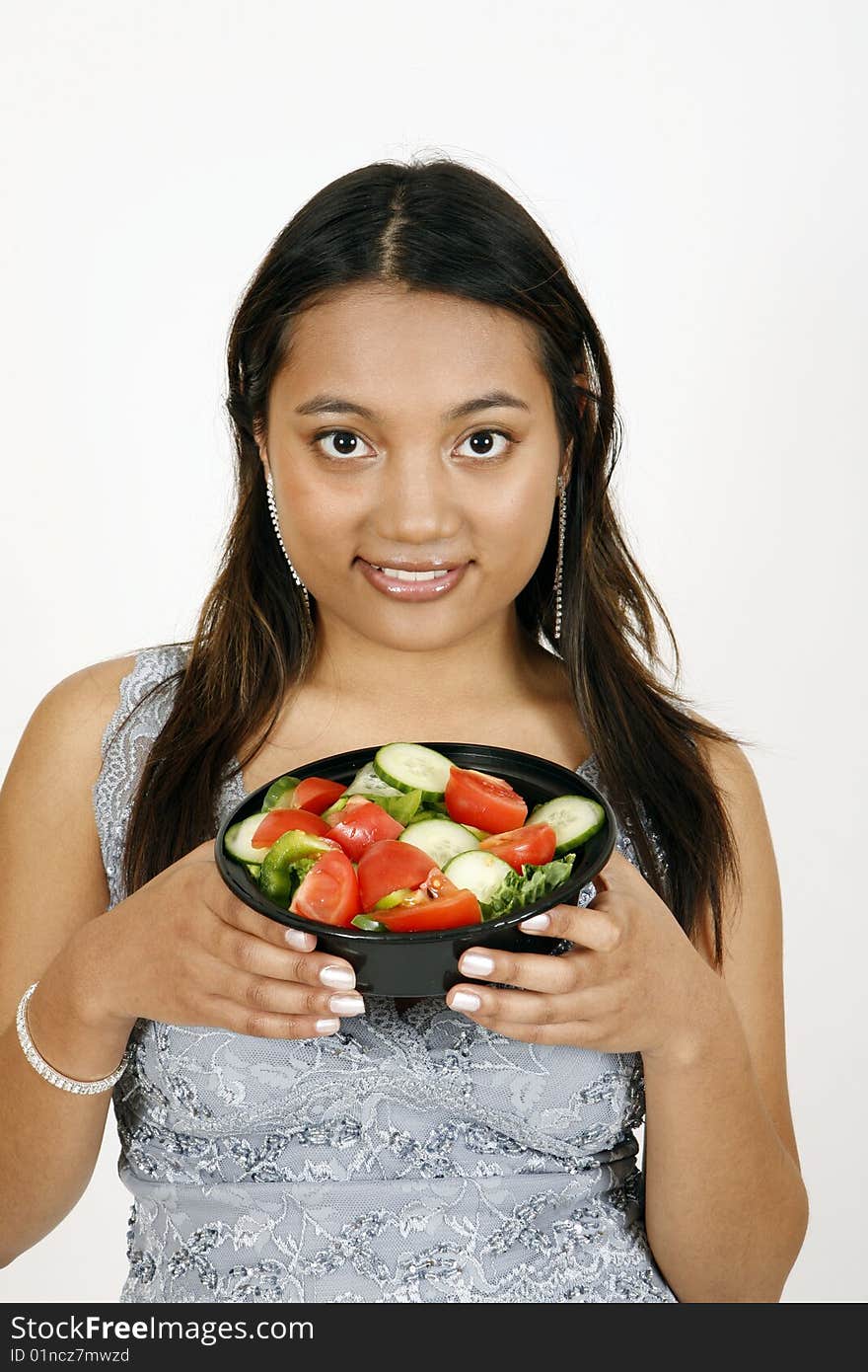 Sweet and pretty girl eating salad and posing