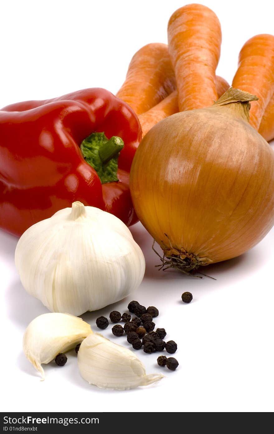 Paprika, onion, carrots and garlic closeup on white background. Paprika, onion, carrots and garlic closeup on white background