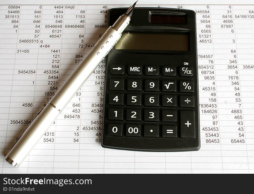 Calculator and pen on a white background. Calculator and pen on a white background