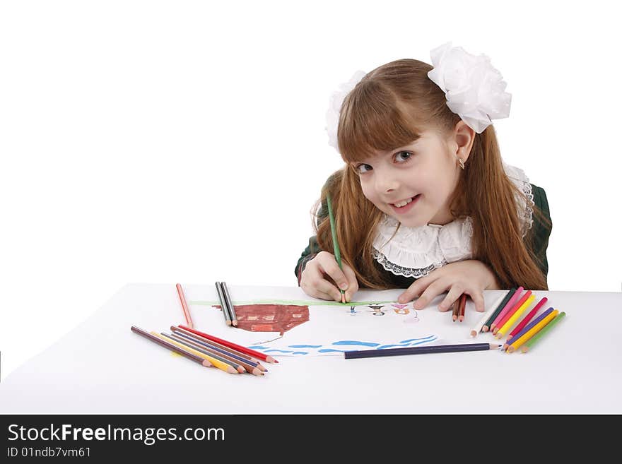 Girl is drawing  in pencil.