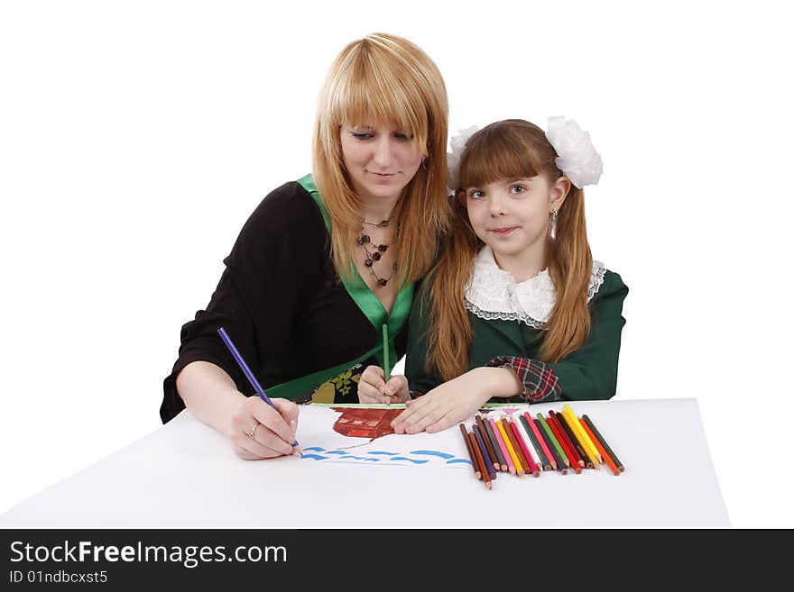 Mother and her young daughter drawing together, set of felt tips on the table. Schoolgirl is  drawing  in pencil. Woman is painting the picture. Isolated over white background. Mother and her young daughter drawing together, set of felt tips on the table. Schoolgirl is  drawing  in pencil. Woman is painting the picture. Isolated over white background.