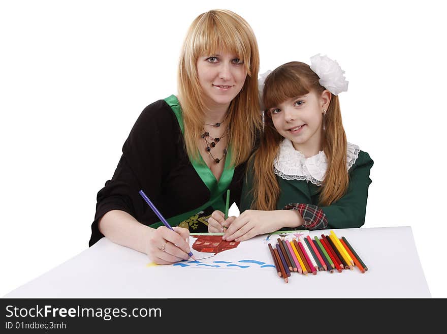 Mother and her young daughter drawing together, set of felt tips on the table. Schoolgirl is drawing in pencil. Woman is painting the picture. Isolated over white background. Mother and her young daughter drawing together, set of felt tips on the table. Schoolgirl is drawing in pencil. Woman is painting the picture. Isolated over white background.