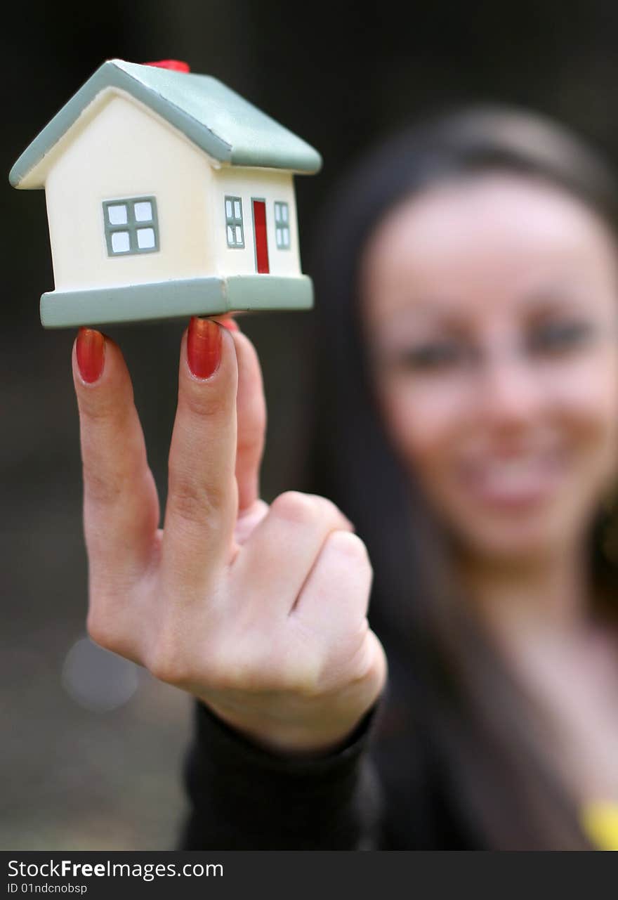 Woman holding house in hand. Woman holding house in hand