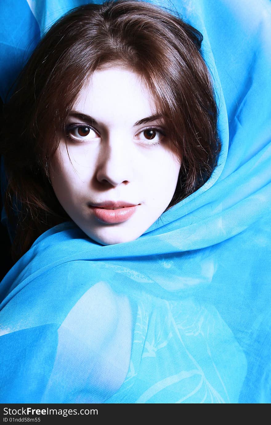 Portrait of the beautiful girl with a blue scarf on a neck. Portrait of the beautiful girl with a blue scarf on a neck.