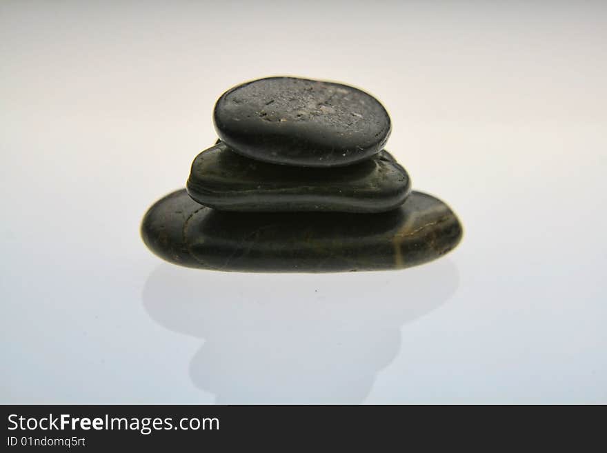 Small stones balanced carefully on top of one another making a stack. Small stones balanced carefully on top of one another making a stack.