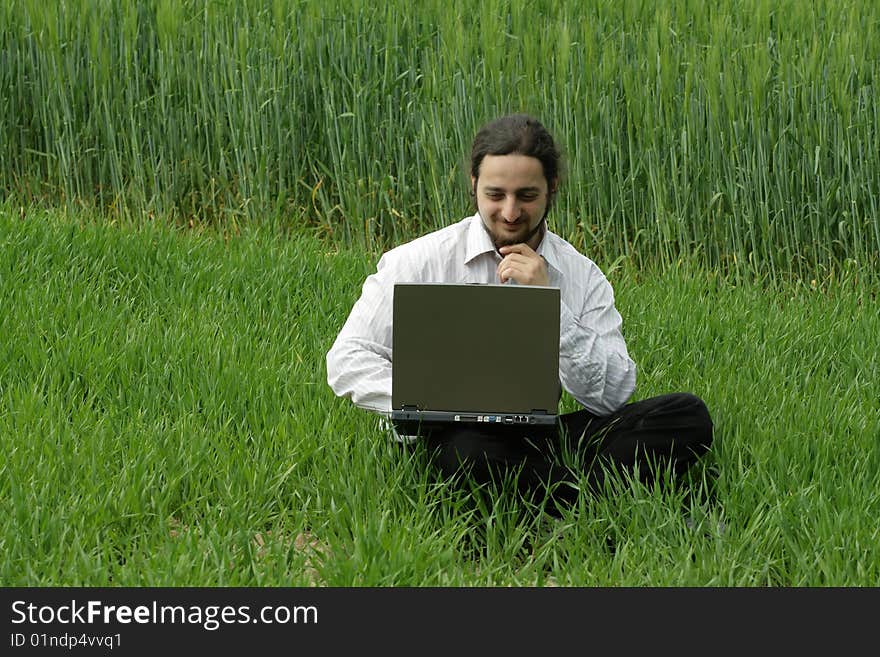 Man Sitting On The Grass, Working