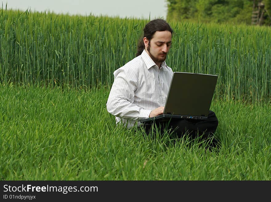 Man Sitting On The Grass, Working