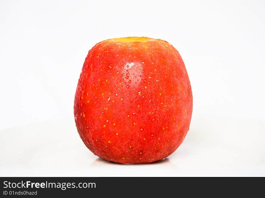 Big Red Apple with water droplets on the textured skin