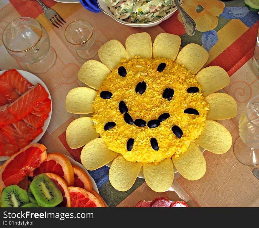 Salad resembling sunflowers on a background of other foods. Salad resembling sunflowers on a background of other foods.