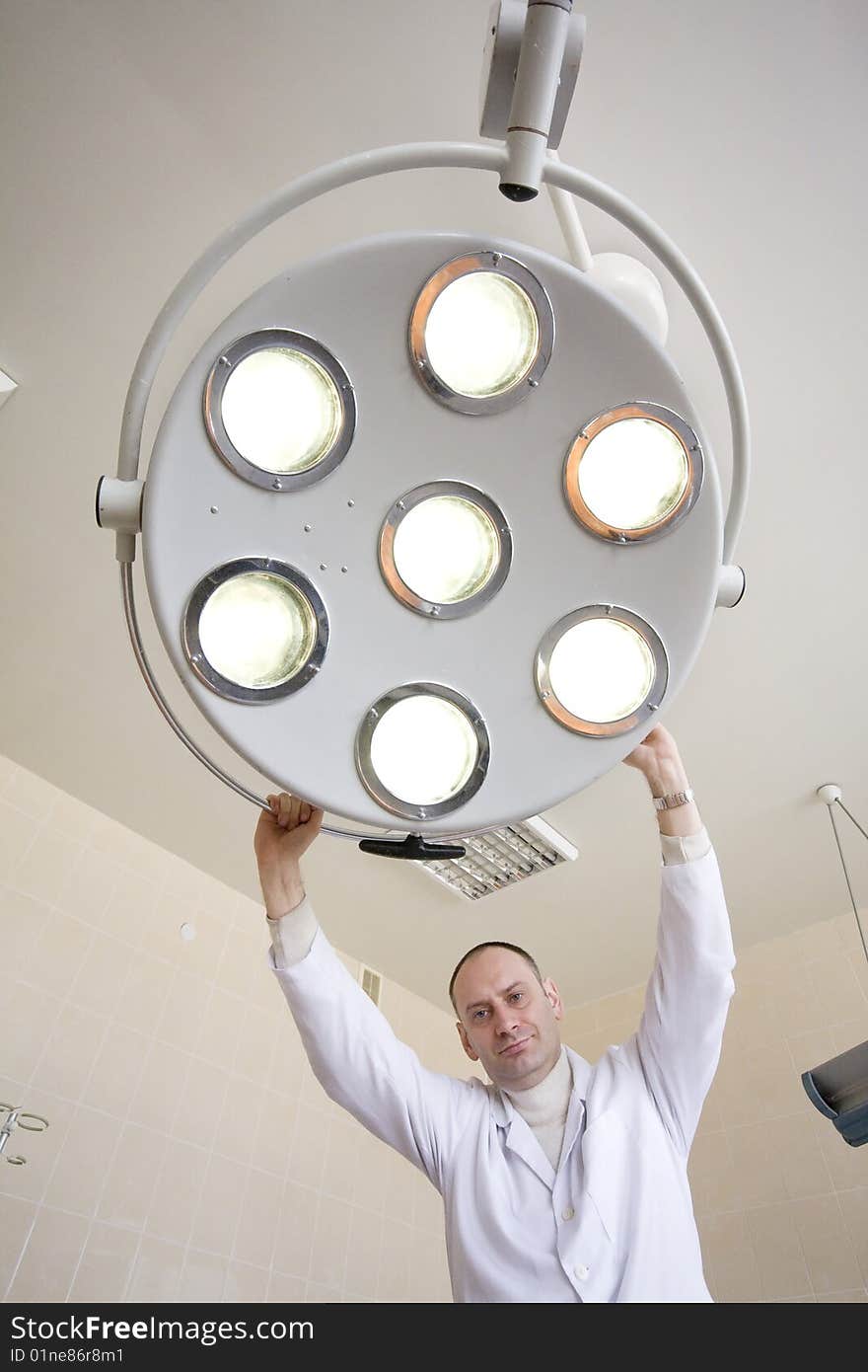 Surgeon with surgical lamp before the operation