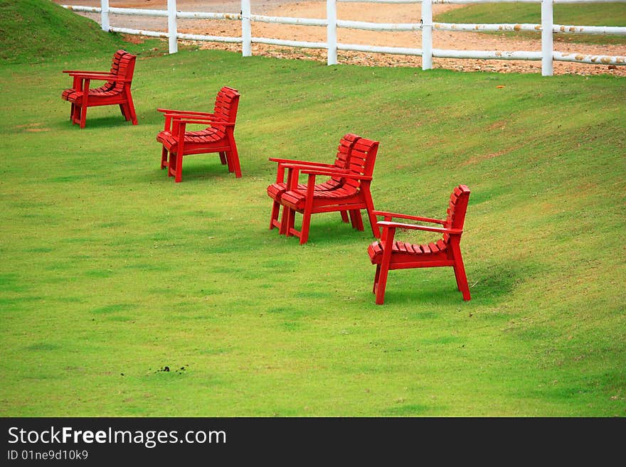 Red chairs on green grass in Suan Pheung Ratchabur