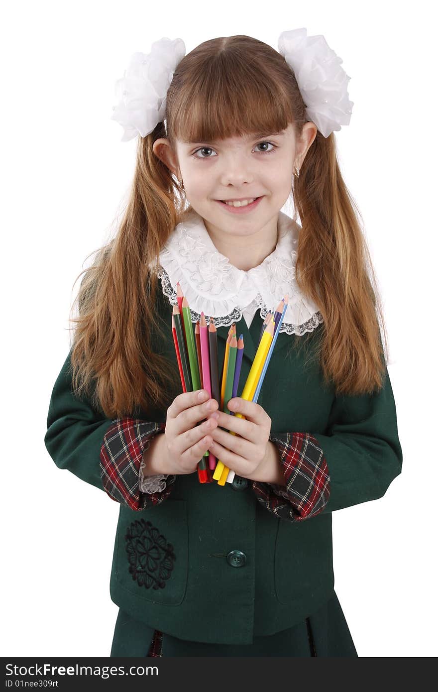 A smiling girl with color pencils in hands on a white background. Schoolgirl is holding coloured pencils.