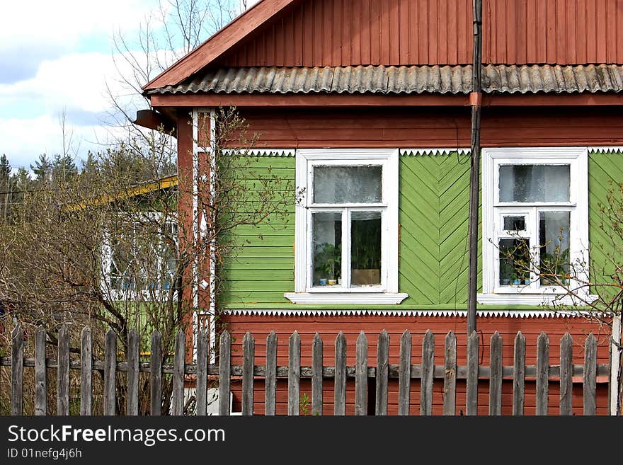 Old-style Russian wooden village house or izba in the countryside. Old-style Russian wooden village house or izba in the countryside