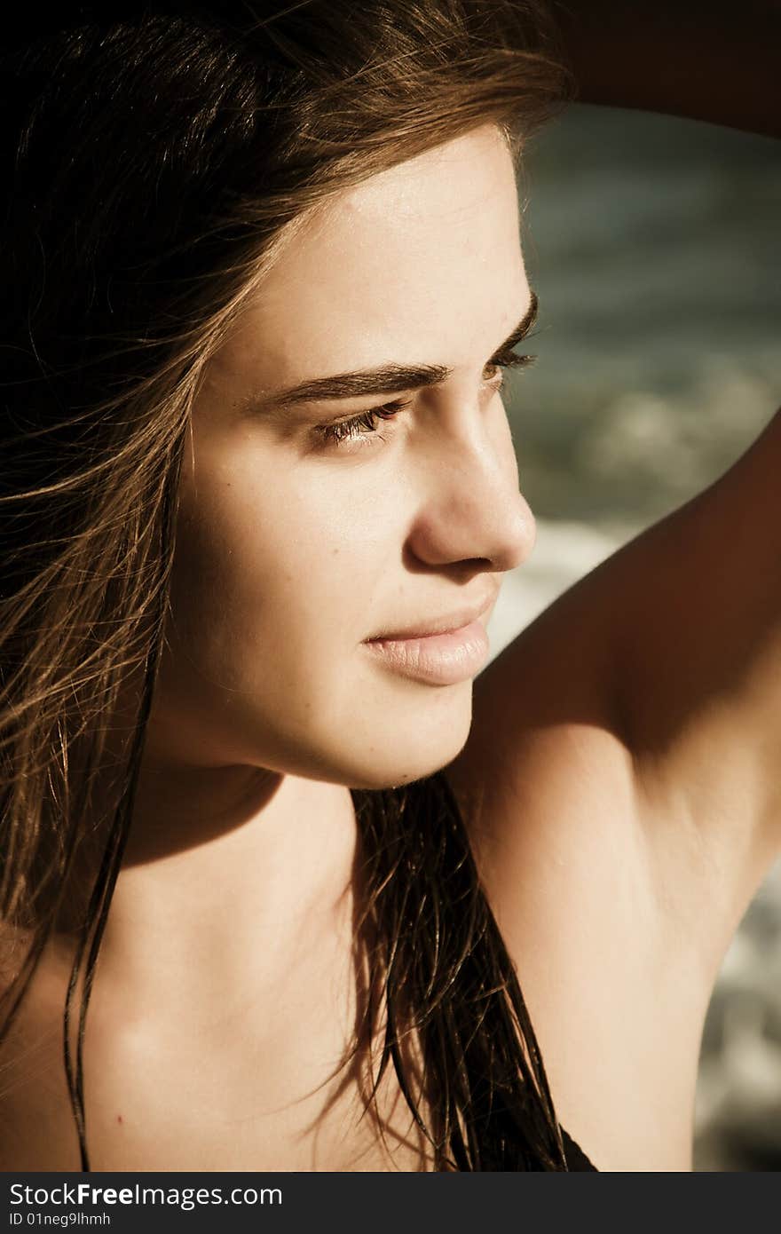 Beautiful green eyed woman portrait with the sea as background. Beautiful green eyed woman portrait with the sea as background.