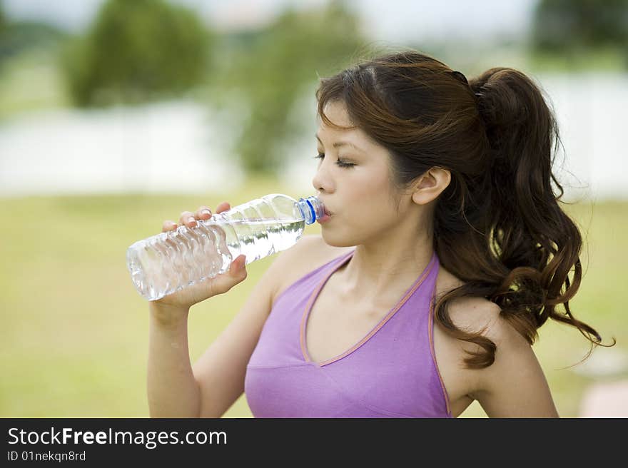 An asian female enjoying her drink. An asian female enjoying her drink.