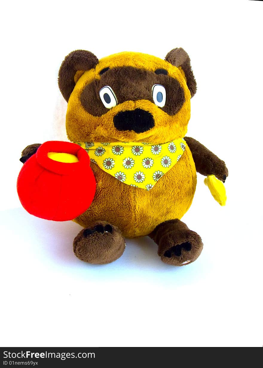 Isolated brown bear toy with honey