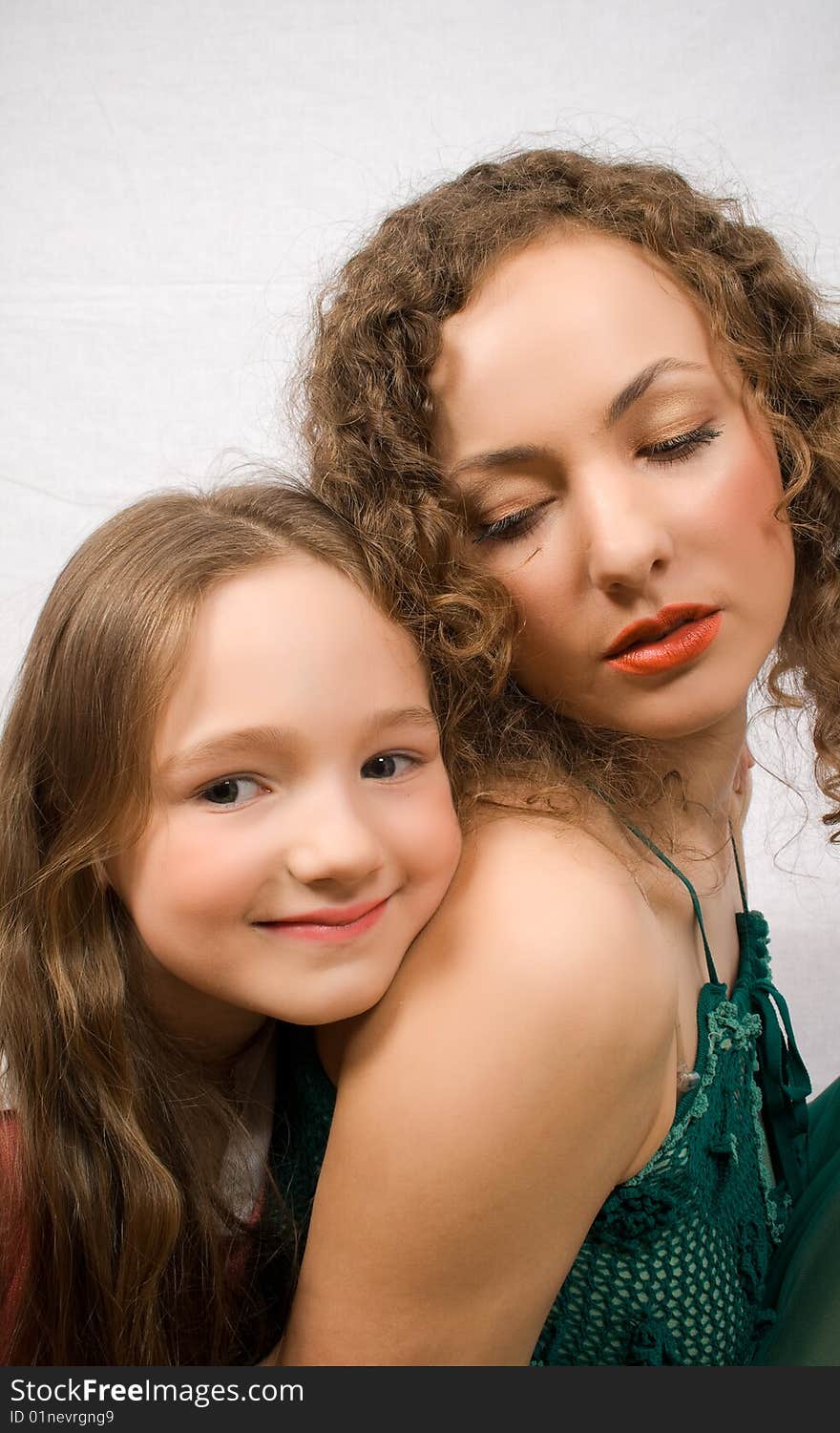 Happy little girl with her mother on white