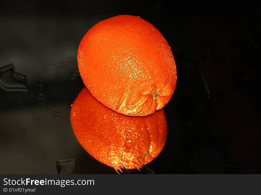 One sweet orange are on black background.