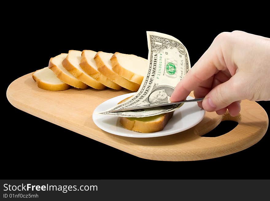 Hand spreads bread with one-dollar banknote on black background. Hand spreads bread with one-dollar banknote on black background