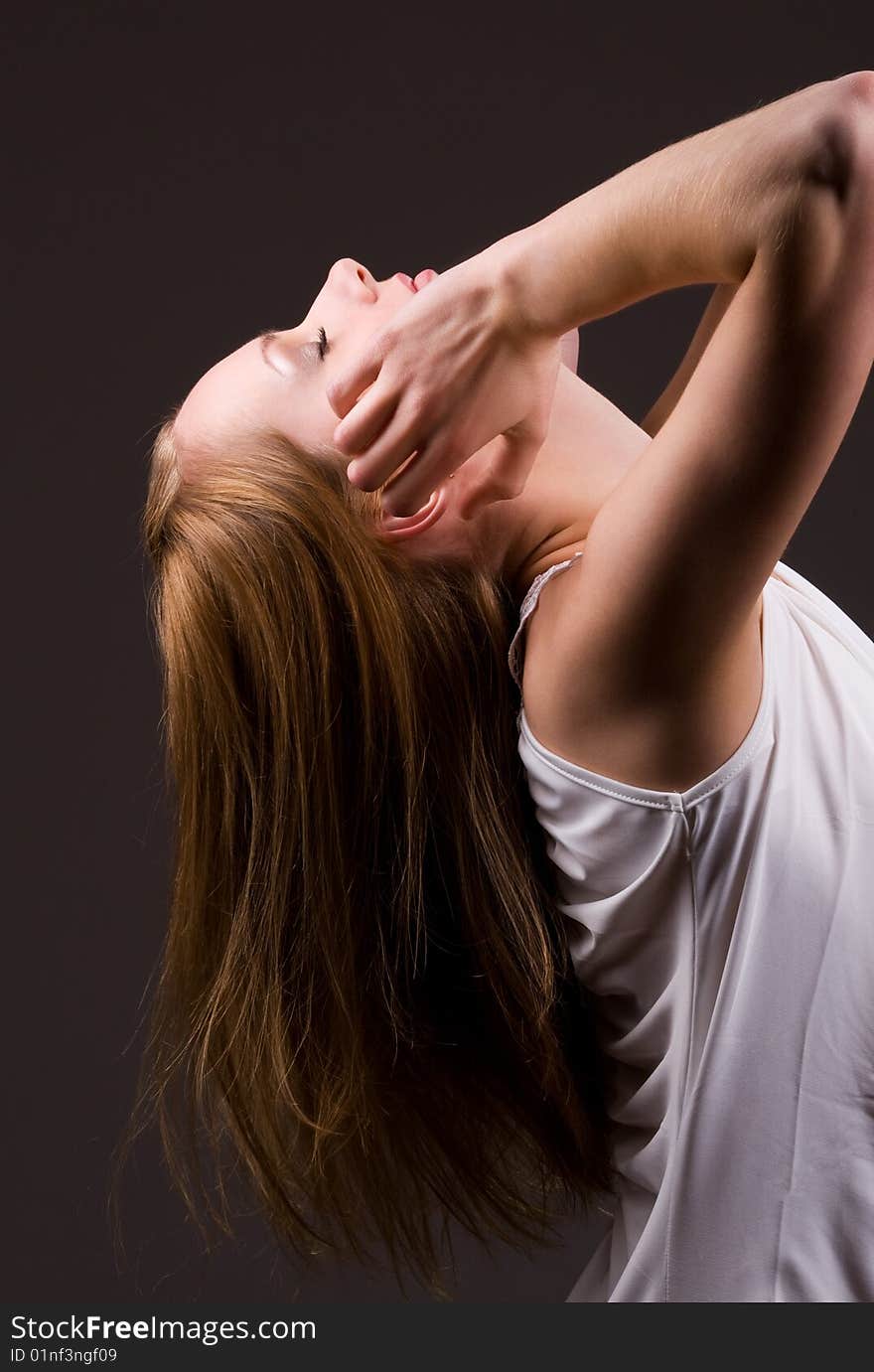 Young caucasian woman throwing head back. Young caucasian woman throwing head back