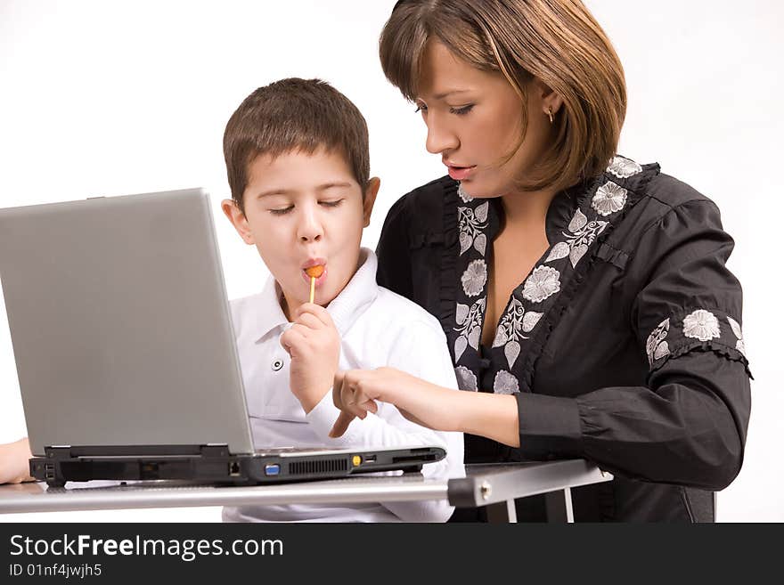 Mother and son playing with laptop over white background. Mother and son playing with laptop over white background