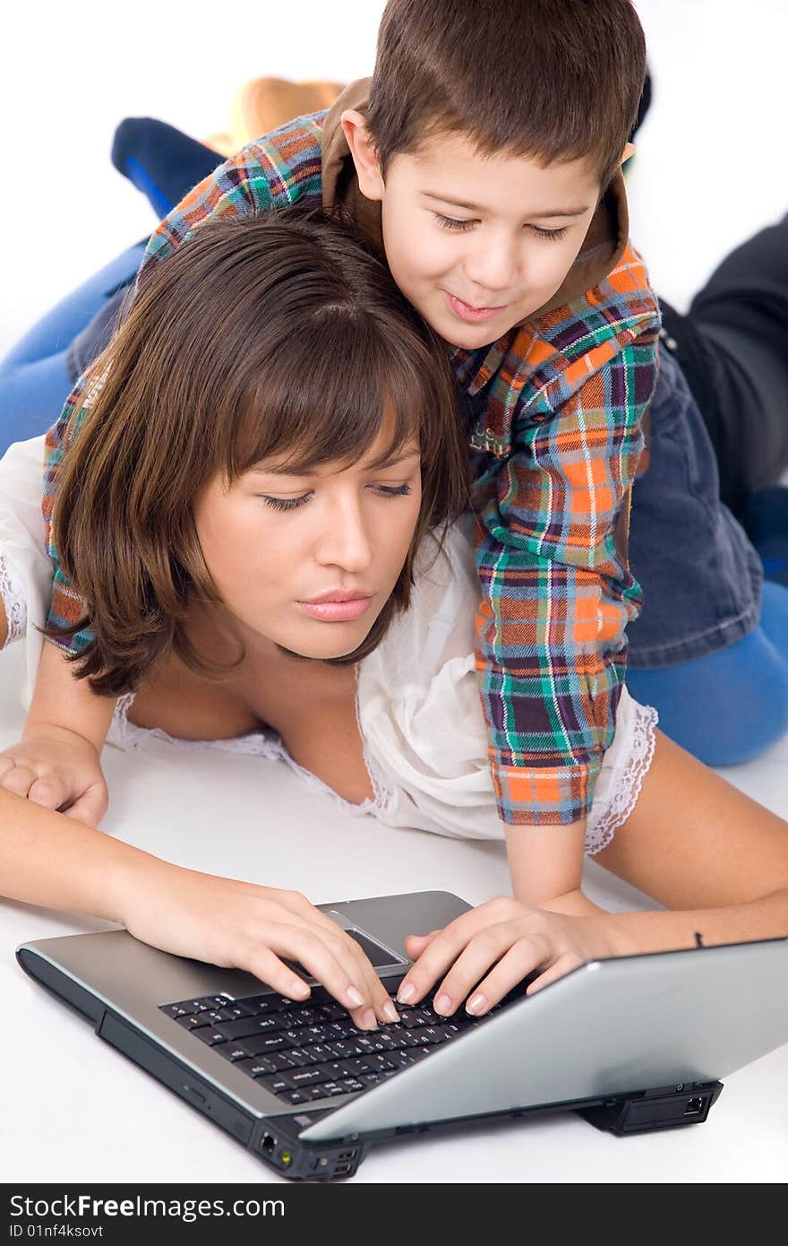 Mother and son playing with laptop over white background. Mother and son playing with laptop over white background