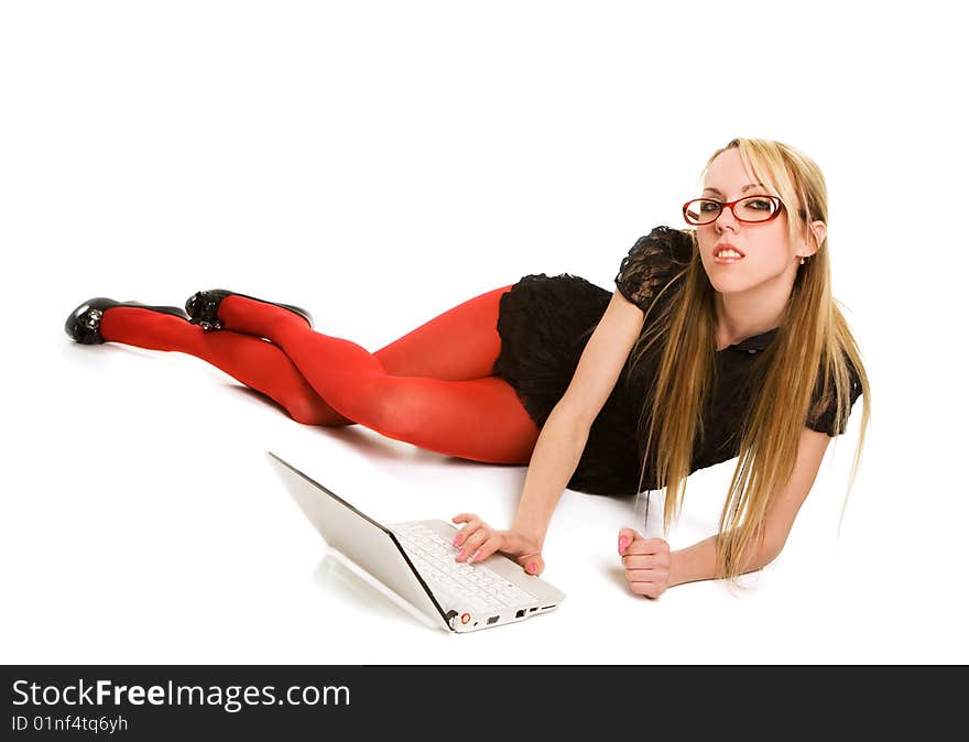 Pretty woman working with laptop on the floor. Isolated