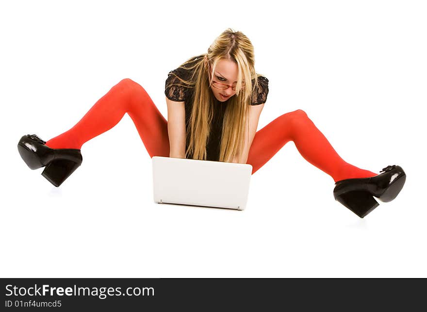 Pretty woman working with laptop on the floor. Isolated