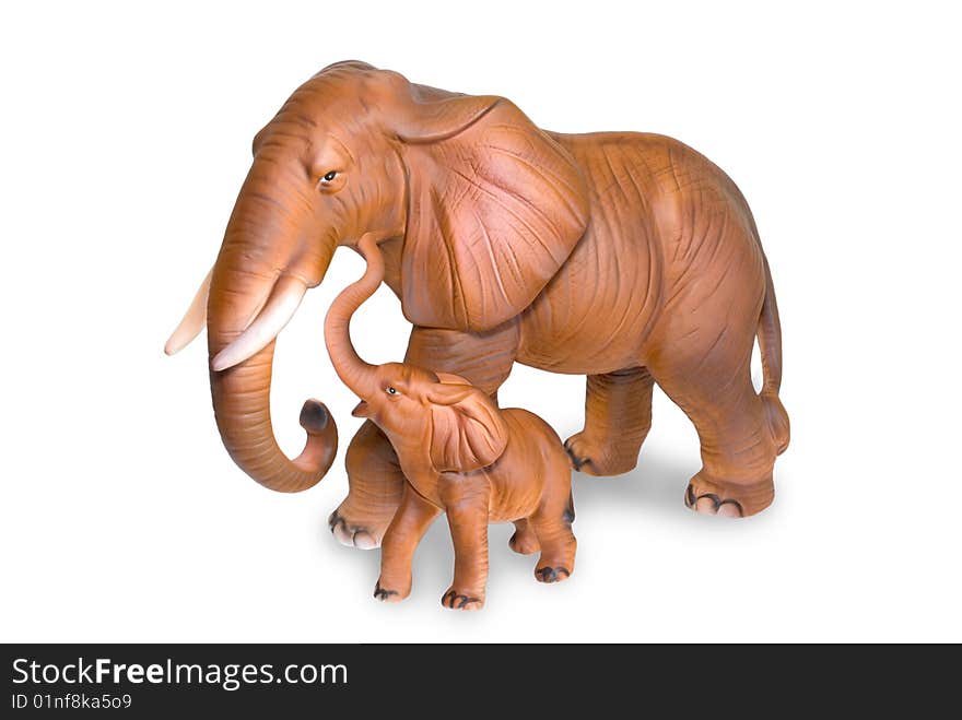 Figurines of an elephant cow and elephant calf are photographed on a white background. Figurines of an elephant cow and elephant calf are photographed on a white background