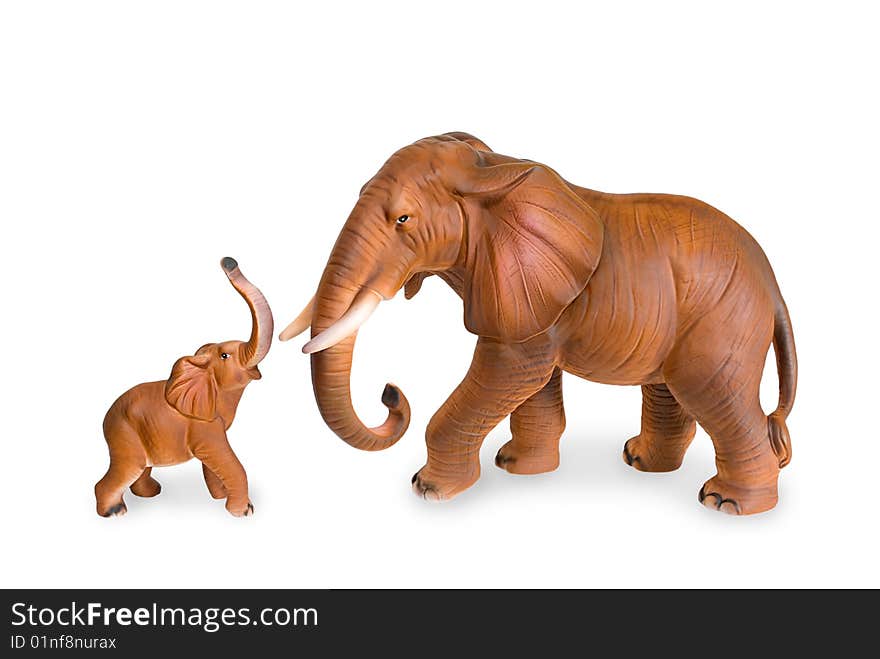 Figurines of an elephant cow and elephant calf are photographed on a white background. Figurines of an elephant cow and elephant calf are photographed on a white background