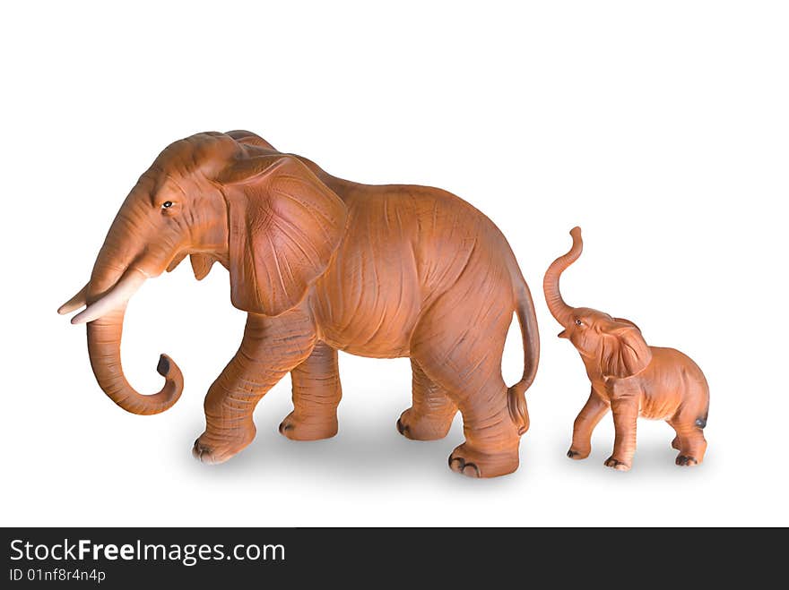 Figurines of an elephant cow and elephant calf are photographed on a white background. Figurines of an elephant cow and elephant calf are photographed on a white background