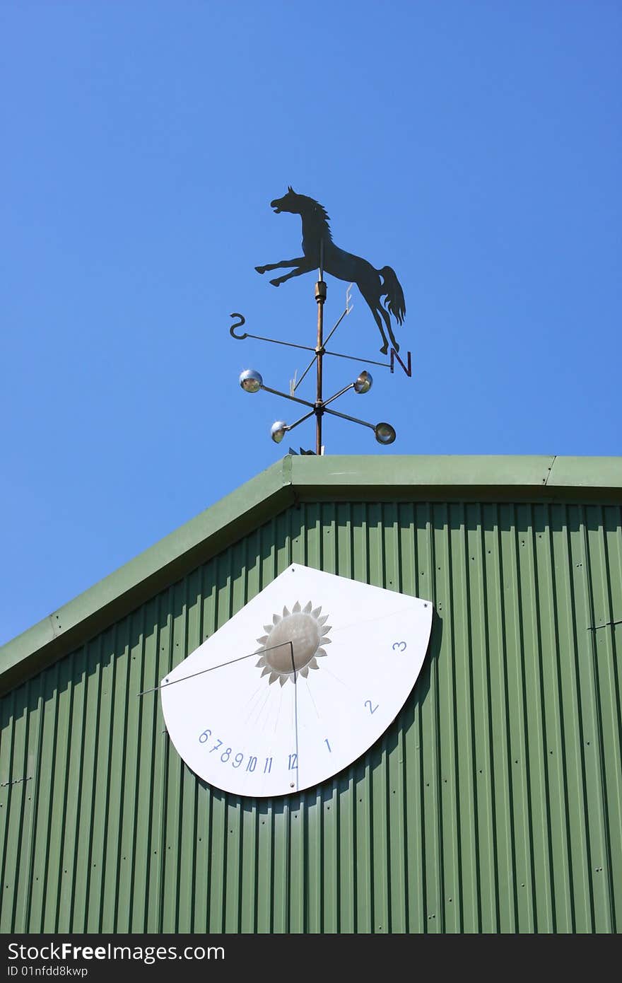 The sun dial with horse vane