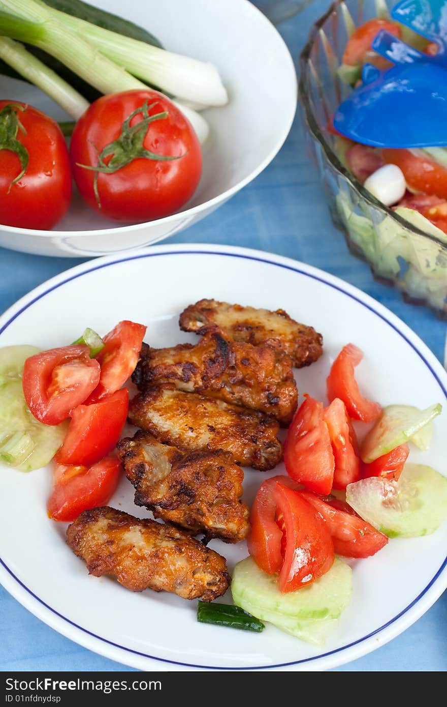 Grilled chicken legs with salad