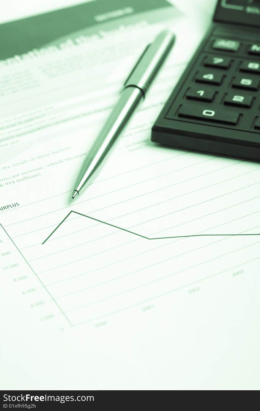 Pencil and calculator over chart report