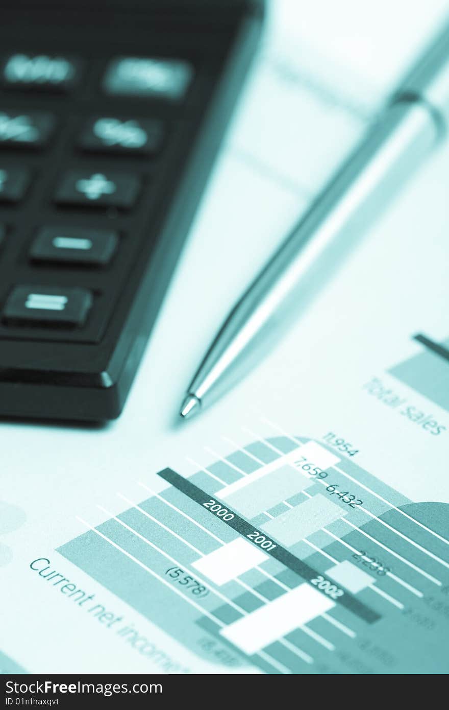 Pencil and calculator over chart report