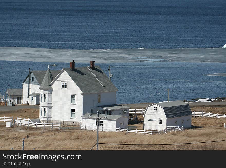 Home with brown grass by the sea. Home with brown grass by the sea.