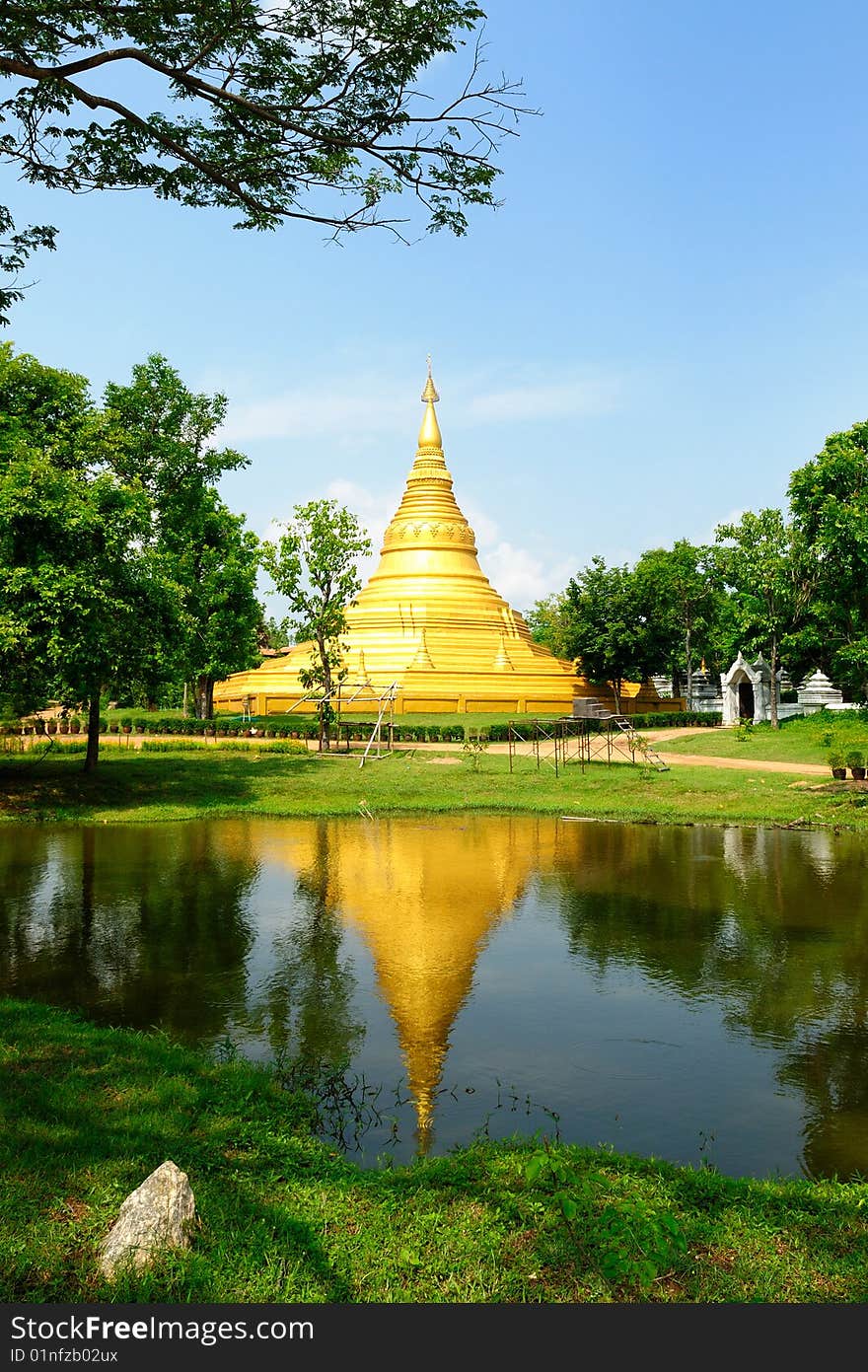 Gold pagoda and reflex on water