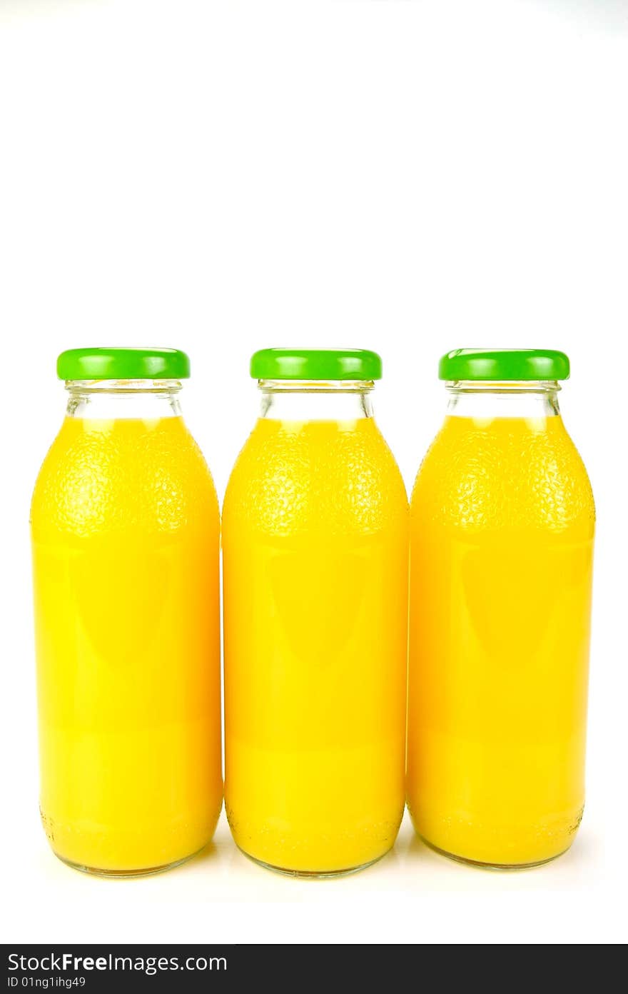 Bottles of orange juice isolated against a white background