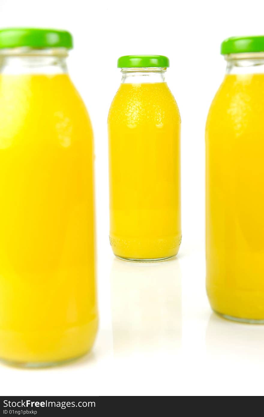 Bottles of orange juice isolated against a white background