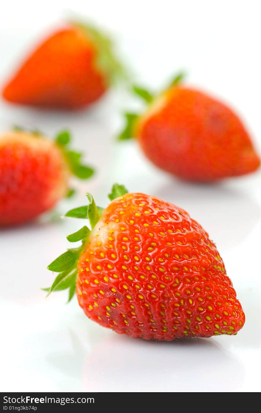 Fresh strawberries isolated against a white background