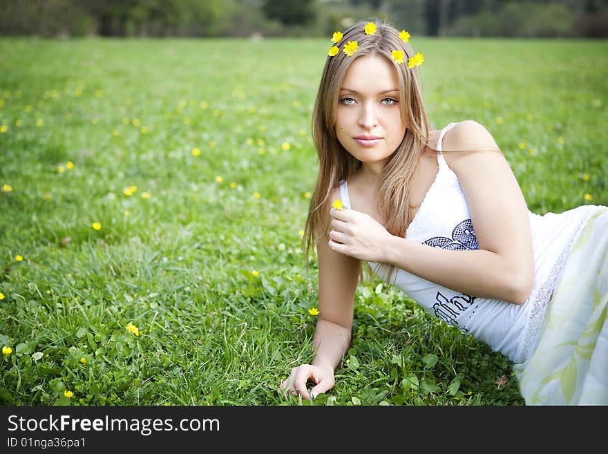 Beautiful young blond woman relaxing in the grass. Beautiful young blond woman relaxing in the grass