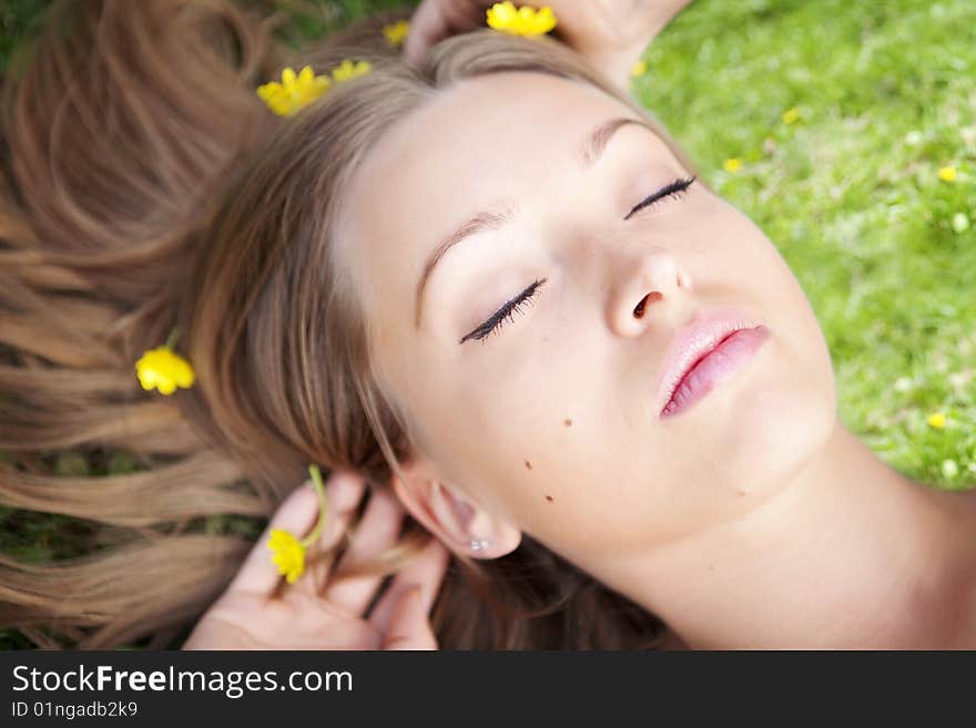 Beautiful young blond woman relaxing in the grass. Beautiful young blond woman relaxing in the grass