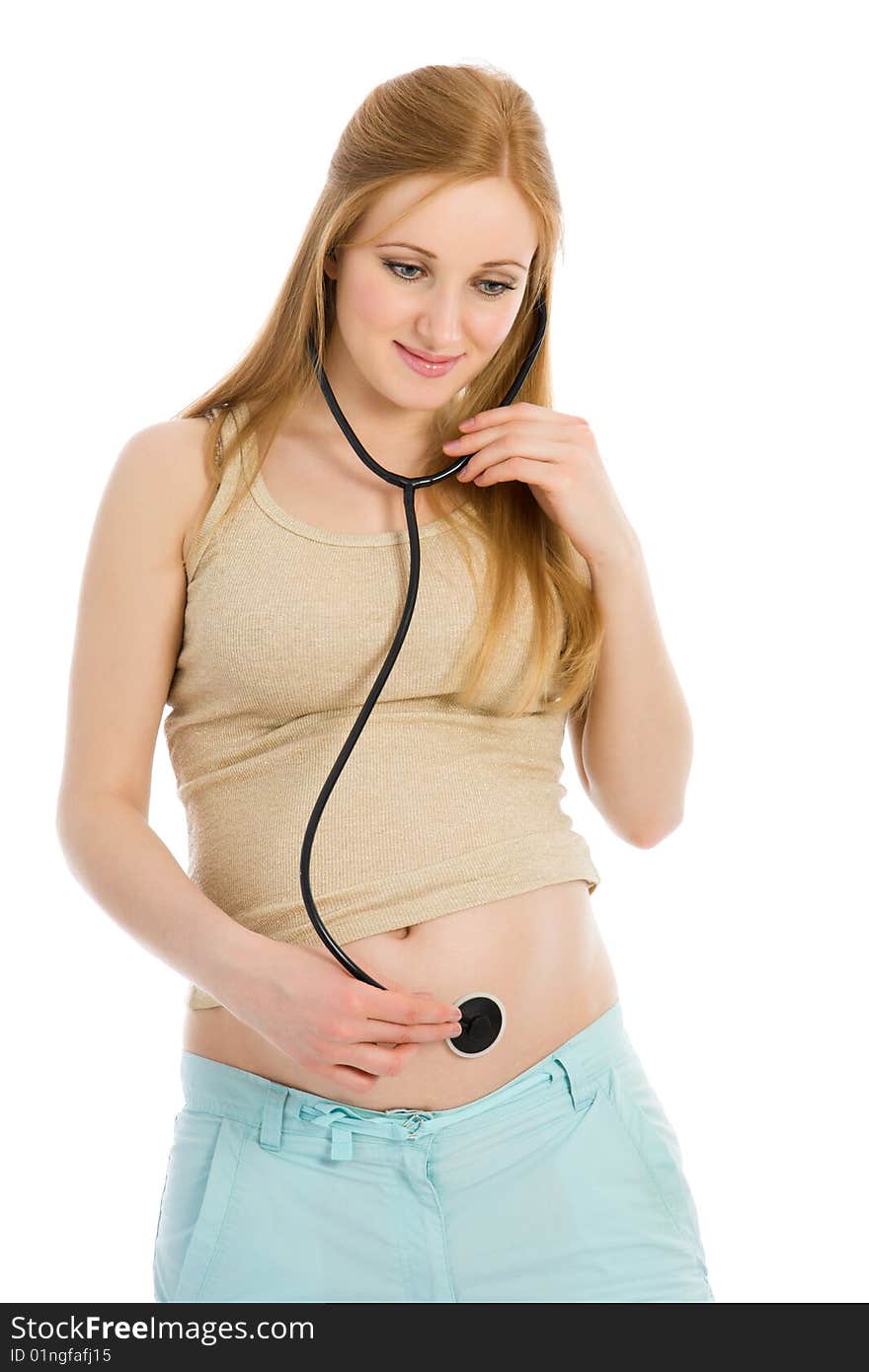 Young pregnant woman listening to belly stethoscope isolated on white