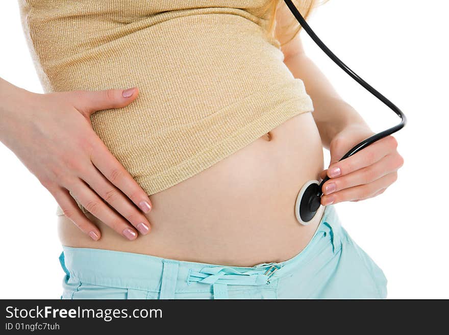 Young pregnant woman listening to belly stethoscope isolated on white