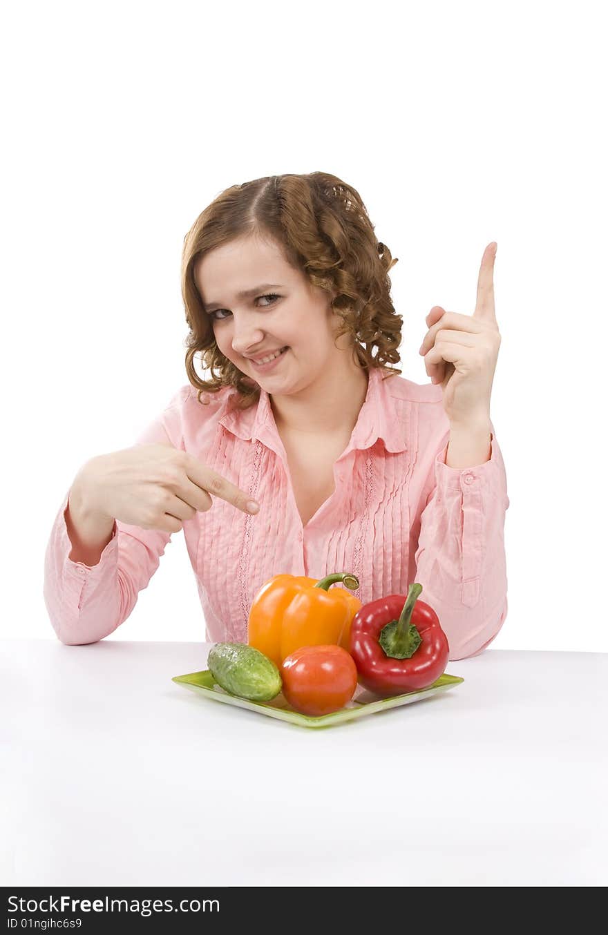 Woman wants to eat fresh vegetables. Housewife is holding the plate with pepper, tomato, cucumber. Pretty girl with pepper, tomato, cucumber. Isolated over white background. Woman wants to eat fresh vegetables. Housewife is holding the plate with pepper, tomato, cucumber. Pretty girl with pepper, tomato, cucumber. Isolated over white background.