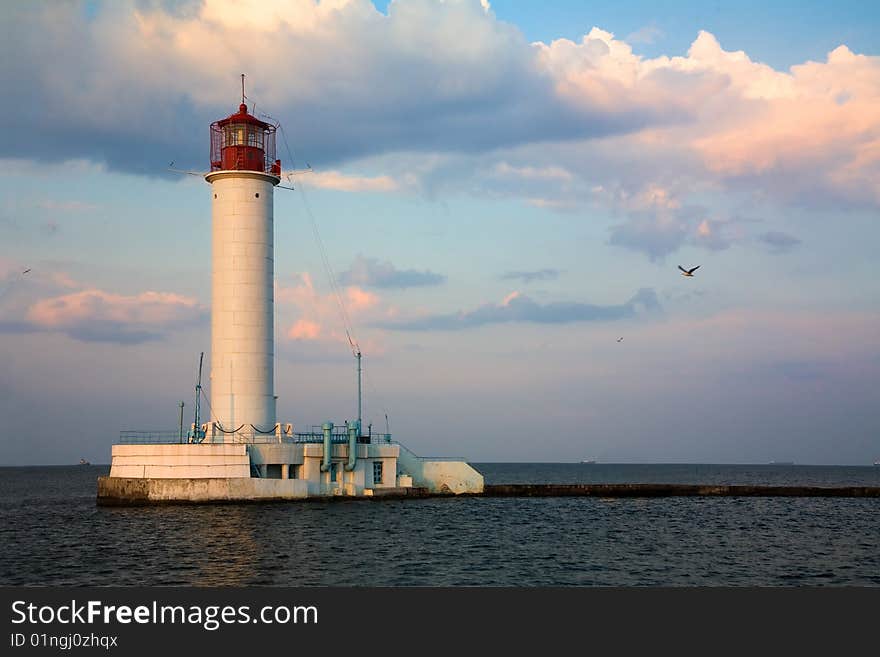 Lighthouse over blue sky background