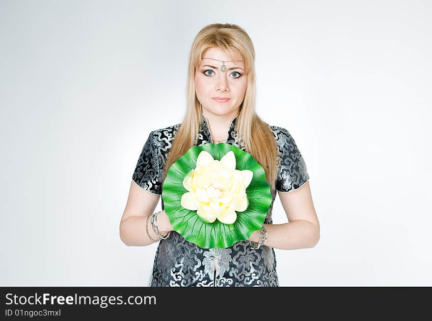 Beautiful woman with lotus flower, studio shot