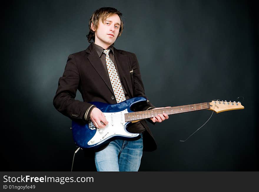 Man playing electro guitar, studio shot