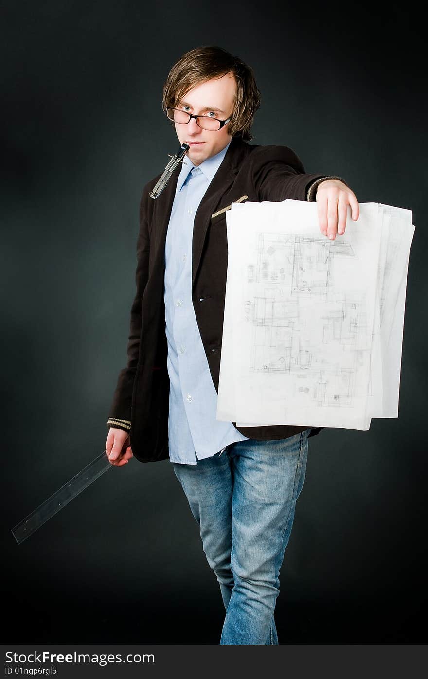 Young architect with sketch, studio shot